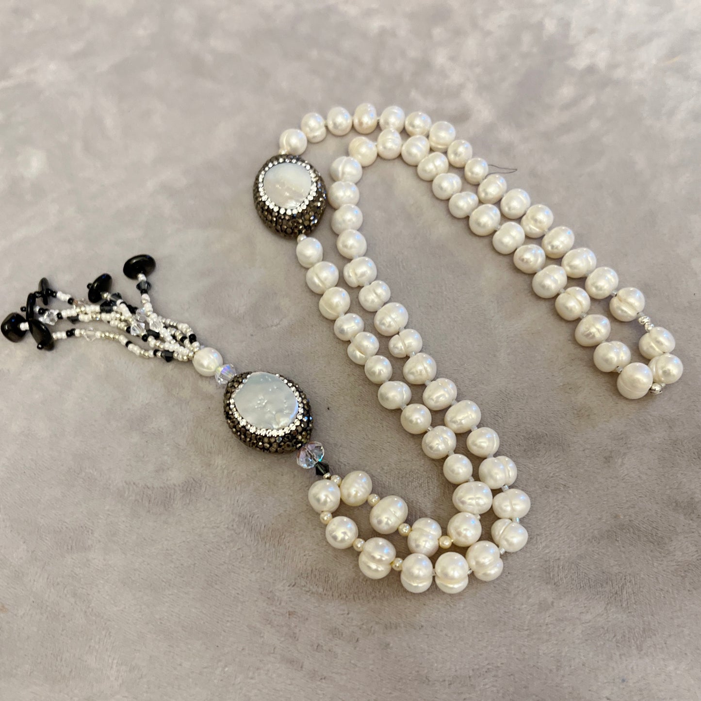 Pearl with elements in Mother of Pearl surrounded by crystals