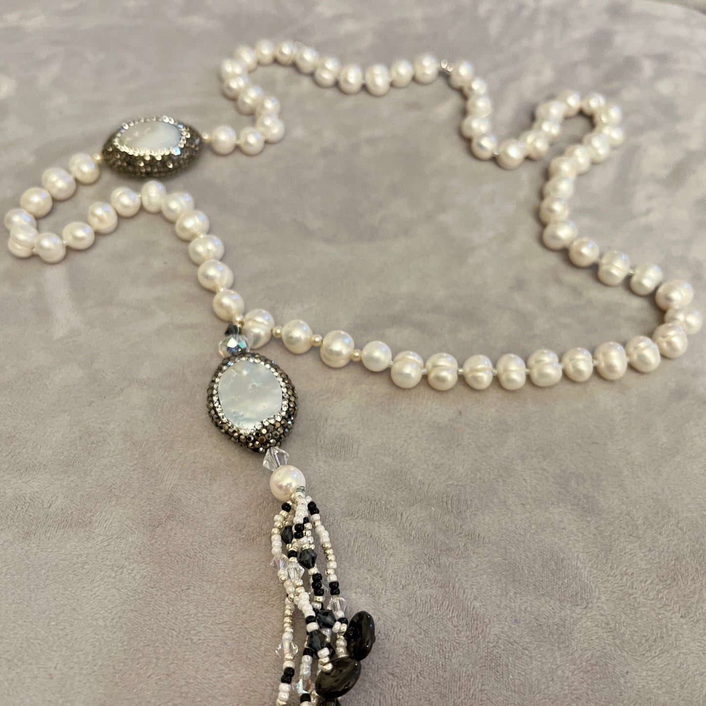 Pearl with elements in Mother of Pearl surrounded by crystals